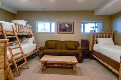 a living room with bunk beds and a couch at Thunder Ridge Chalet by Fernie Lodging Company in Fernie