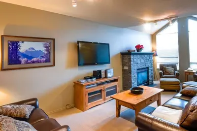 a living room with a couch and a fireplace at Thunder Ridge Chalet by Fernie Lodging Company in Fernie