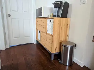 a room with a wooden dresser with a tv on it at Ocean Park Loft in Surrey