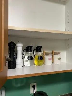 a shelf with some bottles and jars on it at Private basement suite in Langley