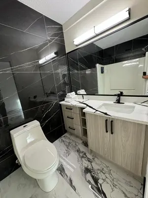 a bathroom with a white toilet and a sink at The Viking Inn in Viking