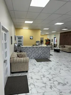 a lobby with a waiting room with couches and tables at The Viking Inn in Viking