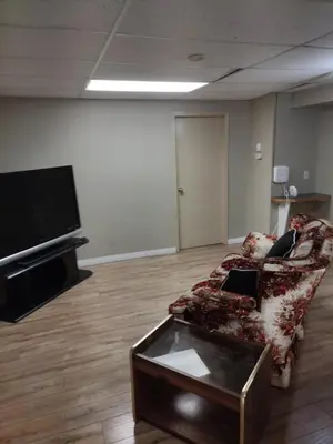 a living room with a couch and a flat screen tv at A Place to Call Home in Edmonton