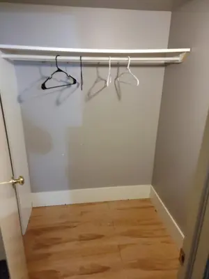 a closet with a shelf on the wall at A Place to Call Home in Edmonton