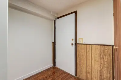 an empty room with a sliding door in it at Simplistic 2BR Suite near Nose Hill & Airport in Calgary