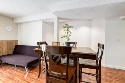 a dining room with a table and chairs at Simplistic 2BR Suite near Nose Hill & Airport in Calgary