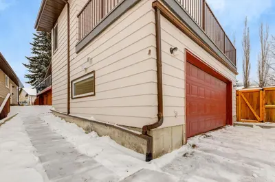 a garage with a red garage door on a house at Simplistic 2BR Suite near Nose Hill & Airport in Calgary