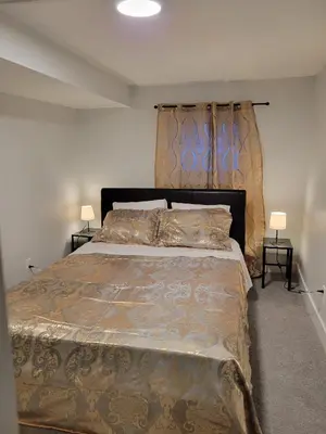 a bedroom with a large bed and two lamps at Private Family Hideaway or Business Travel in Edmonton - 2 Bedroom Apartment in Edmonton