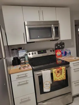 a kitchen with a stove and a microwave at Private Family Hideaway or Business Travel in Edmonton - 2 Bedroom Apartment in Edmonton