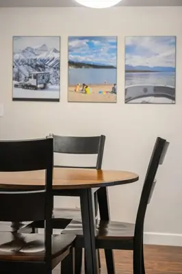 a dining room table and chairs with pictures on the wall at Lakeside Memories, Pool, Hot Tub, Central in Invermere
