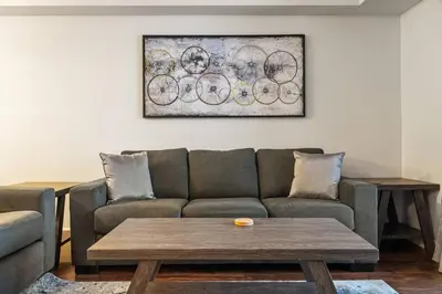 a living room with a couch and a table at Lakeside Memories, Pool, Hot Tub, Central in Invermere