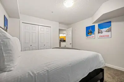a bedroom with a large white bed in it at Lakeside Memories, Pool, Hot Tub, Central in Invermere