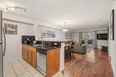 an open kitchen and living room with a counter top at Lakeside Memories, Pool, Hot Tub, Central in Invermere