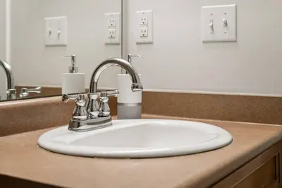 a bathroom counter with a sink with a white sink at Lakeside Memories, Pool, Hot Tub, Central in Invermere