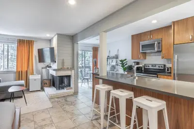 an open kitchen and living room with a fireplace at Whistler Studio by Gondola & Free Parking in Whistler