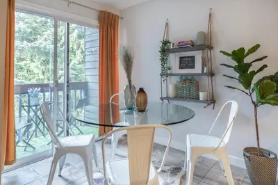 a dining room with a glass table and white chairs at Whistler Studio by Gondola & Free Parking in Whistler