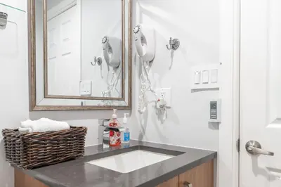 a bathroom with a sink and a mirror and a shower at Whistler Studio by Gondola & Free Parking in Whistler