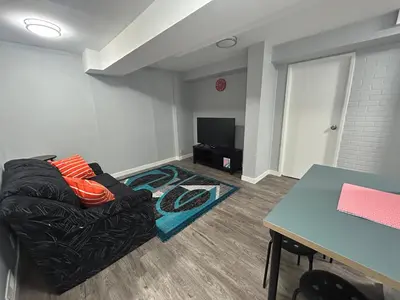 a living room with a couch and a table at Cute Highland Park Entire Unit A in Calgary