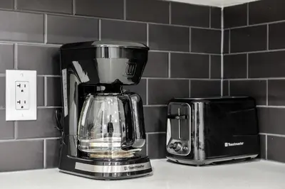 a coffee maker and a toaster on a kitchen counter at Angie’s place in Calgary