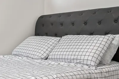 a bed with two pillows on top of it at Angie’s place in Calgary