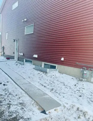 a red building with snow on the side of it at Angie’s place in Calgary