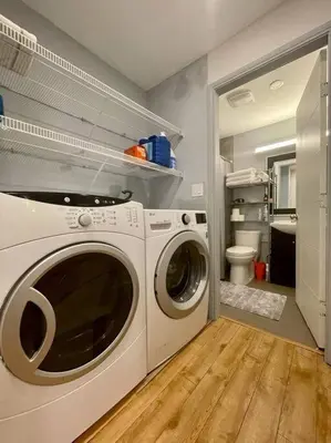 a laundry room with a washer and a toilet at Westview Vacation Rental - Two BR House in North Vancouver