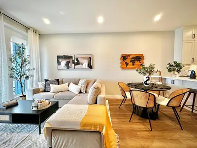 a living room with a couch and a table at Dreamy Panoramic Lakeview 1 Bedroom plus Den in Harrison Hot Springs