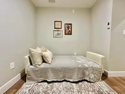 a bedroom with a bed with pillows on it at Dreamy Panoramic Lakeview 1 Bedroom plus Den in Harrison Hot Springs