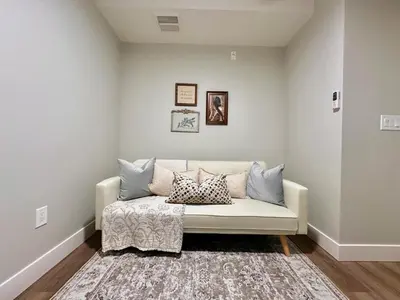 a living room with a couch with pillows on it at Dreamy Panoramic Lakeview 1 Bedroom plus Den in Harrison Hot Springs