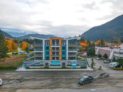 a parking lot in front of a large building at Dreamy Panoramic Lakeview 1 Bedroom plus Den in Harrison Hot Springs