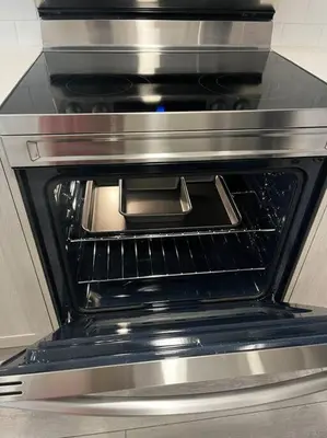 an oven with its door open in a kitchen at Brand New - Home Away from Home in NW Calgary in Calgary