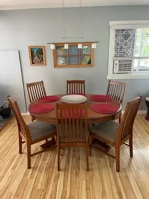 a dining room with a wooden table and chairs at Sweet Creek Retreat in Nelson