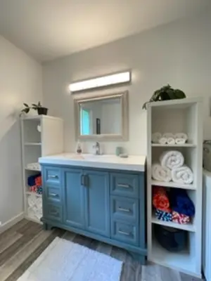 a bathroom with a blue sink and a mirror at Sweet Creek Retreat in Nelson