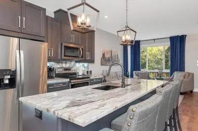 a kitchen with a large marble counter top at Vi Cottage in North Saanich