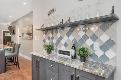 a kitchen with a counter with wine glasses at Vi Cottage in North Saanich