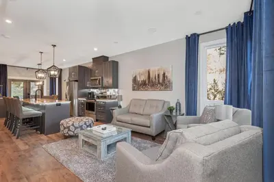 a living room with a couch and a table at Vi Cottage in North Saanich