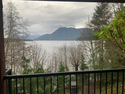 a view of a lake from a balcony at Shoreside Private room in Sechelt