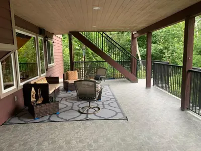 a screened in porch with chairs and furniture on it at Shoreside Private room in Sechelt