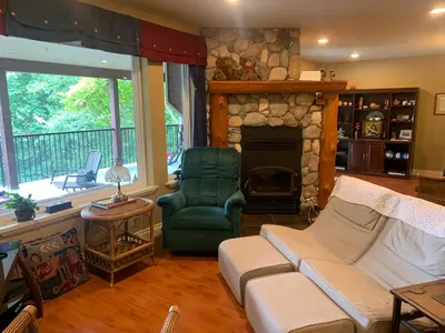 a living room with a couch and a fireplace at Shoreside Private room in Sechelt