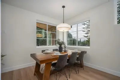 a dining room with a wooden table and chairs at Black Diamond Cabin - Sasquatch Mountain Resort in Agassiz