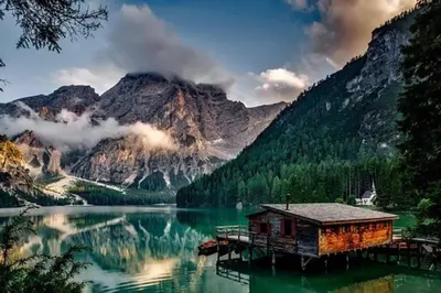 a cabin on a dock in the middle of a lake at The Grand Escape Downtown Canmore in Canmore