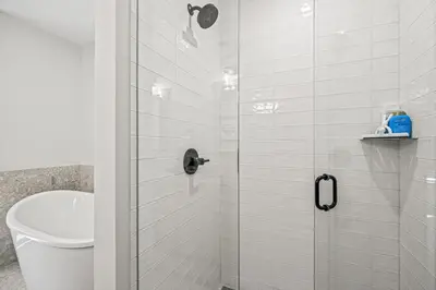 a bathroom with a shower with a toilet and a sink at Serenity Villa at Tamarack in Canmore