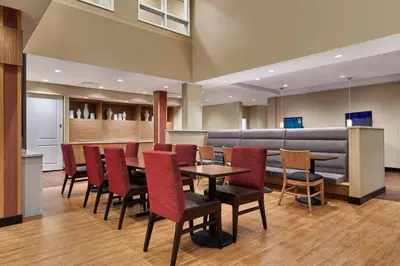 a waiting room with a table and chairs at TownePlace Suites by Marriott Fort McMurray in Fort McMurray