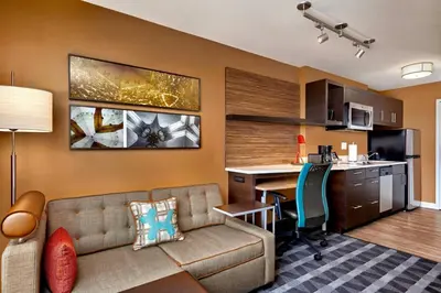 a living room with a couch and a desk at TownePlace Suites by Marriott Fort McMurray in Fort McMurray