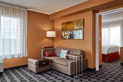 a living room with a couch and a bed at TownePlace Suites by Marriott Fort McMurray in Fort McMurray
