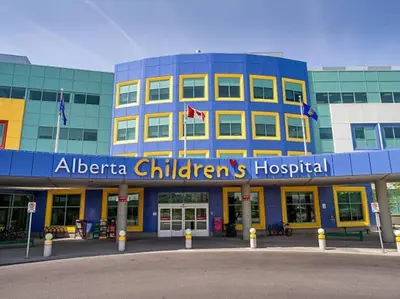 a building with a sign on the front of it at UC Stampede Condo by Train, Hospital, free UG parking & Gym, AC, full kitchen in Calgary