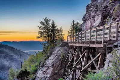 a train on a bridge on the side of a mountain at Kelowna family-friendly lake & Mountain view Luxury condo with AC, pool, Hot tub, near winery and shopping center in West Kelowna