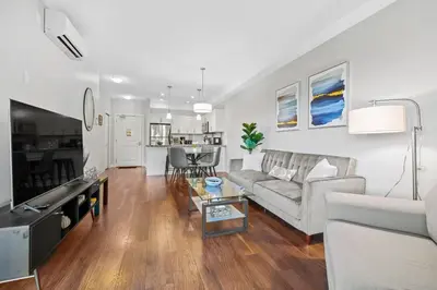 a living room with a couch and a table at Kelowna family-friendly lake & Mountain view Luxury condo with AC, pool, Hot tub, near winery and shopping center in West Kelowna