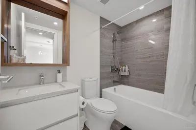 a bathroom with a toilet and a tub and a sink at Stylish and Tranquil Retreat in Richmond City Center in Richmond