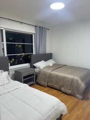 a bedroom with two beds and a window at Home in West Vancouver in West Vancouver